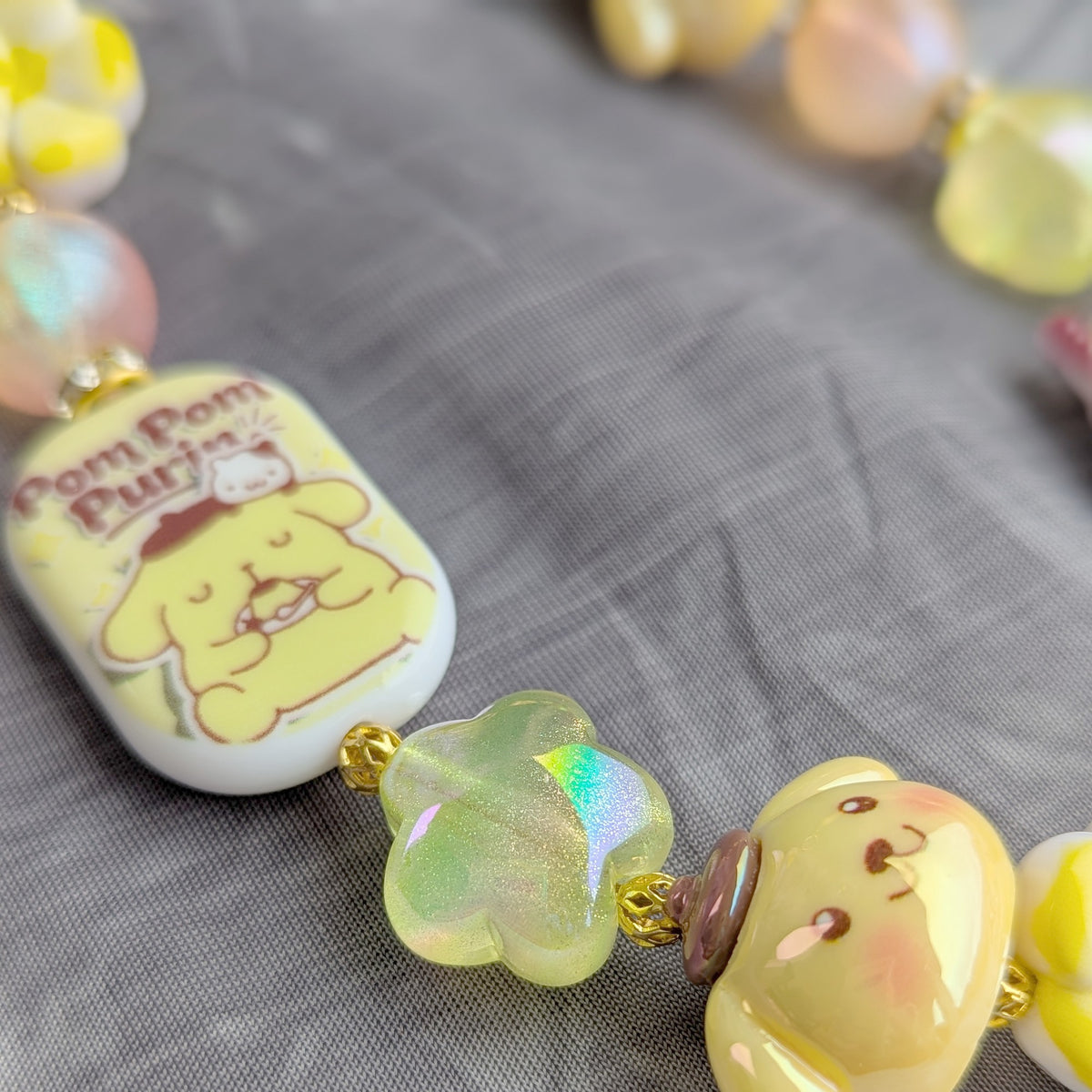 Pompompurin Yellow Beaded Bag Charm - close-up